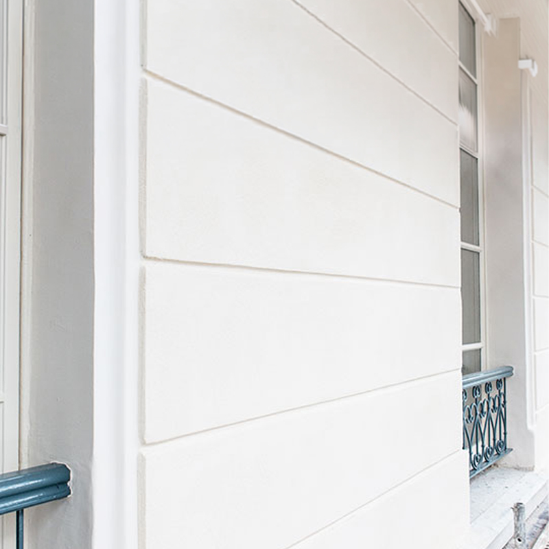 Façade avec finition lisse réalisée avec un enduit chaux Tilia Mix P